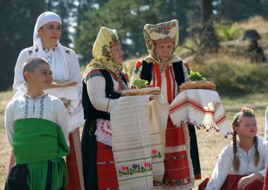 Koprivshtica, Bulgaria - August 6, 2022: People in traditional folk costume of The National Folklore Fair in Koprivshtica. The National Folklore Fair in Koprivshtica is entered in the UNESCO Register of the human intangible cultural heritage