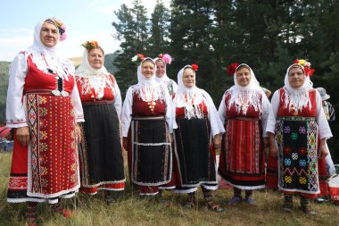 Koprivshtica, Bulgaria - August 6, 2022: People in traditional folk costume of The National Folklore Fair in Koprivshtica. The National Folklore Fair in Koprivshtica is entered in the UNESCO Register of the human intangible cultural heritage
