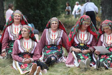 Koprivshtica, Bulgaria - August 6, 2022: People in traditional folk costume of The National Folklore Fair in Koprivshtica. The National Folklore Fair in Koprivshtica is entered in the UNESCO Register of the human intangible cultural heritage