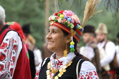 Koprivshtica, Bulgaria - August 6, 2022: People in traditional folk costume of The National Folklore Fair in Koprivshtica. The National Folklore Fair in Koprivshtica is entered in the UNESCO Register of the human intangible cultural heritage