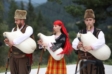 Koprivshtica, Bulgaria - August 6, 2022: People in traditional folk costume of The National Folklore Fair in Koprivshtica. The National Folklore Fair in Koprivshtica is entered in the UNESCO Register of the human intangible cultural heritage