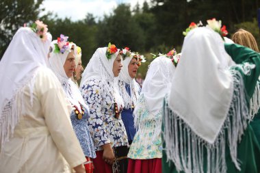 Koprivshtica, Bulgaria - August 6, 2022: People in traditional folk costume of The National Folklore Fair in Koprivshtica. The National Folklore Fair in Koprivshtica is entered in the UNESCO Register of the human intangible cultural heritage