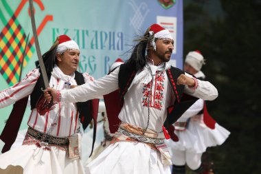 Koprivshtica, Bulgaria - August 6, 2022: People in traditional folk costume of The National Folklore Fair in Koprivshtica. The National Folklore Fair in Koprivshtica is entered in the UNESCO Register of the human intangible cultural heritage