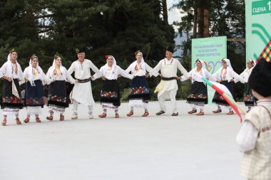 Koprivshtica, Bulgaria - August 6, 2022: People in traditional folk costume of The National Folklore Fair in Koprivshtica. The National Folklore Fair in Koprivshtica is entered in the UNESCO Register of the human intangible cultural heritage
