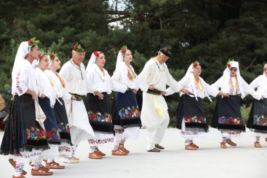 Koprivshtica, Bulgaria - August 6, 2022: People in traditional folk costume of The National Folklore Fair in Koprivshtica. The National Folklore Fair in Koprivshtica is entered in the UNESCO Register of the human intangible cultural heritage
