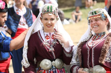 Koprivshtica, Bulgaria - August 6, 2022: People in traditional folk costume of The National Folklore Fair in Koprivshtica. The National Folklore Fair in Koprivshtica is entered in the UNESCO Register of the human intangible cultural heritage