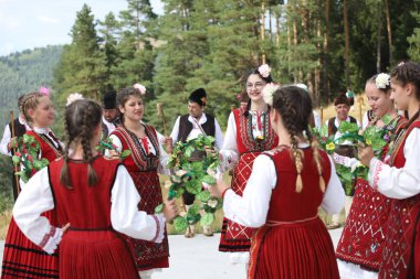 Koprivshtica, Bulgaria - August 6, 2022: People in traditional folk costume of The National Folklore Fair in Koprivshtica. The National Folklore Fair in Koprivshtica is entered in the UNESCO Register of the human intangible cultural heritage