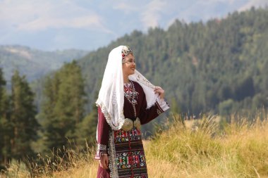 Koprivshtica, Bulgaria - August 6, 2022: People in traditional folk costume of The National Folklore Fair in Koprivshtica. The National Folklore Fair in Koprivshtica is entered in the UNESCO Register of the human intangible cultural heritage