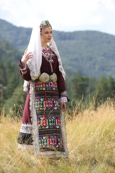 Koprivshtica, Bulgaria - August 6, 2022: People in traditional folk costume of The National Folklore Fair in Koprivshtica. The National Folklore Fair in Koprivshtica is entered in the UNESCO Register of the human intangible cultural heritage