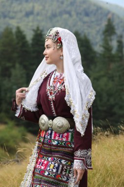 Koprivshtica, Bulgaria - August 6, 2022: People in traditional folk costume of The National Folklore Fair in Koprivshtica. The National Folklore Fair in Koprivshtica is entered in the UNESCO Register of the human intangible cultural heritage