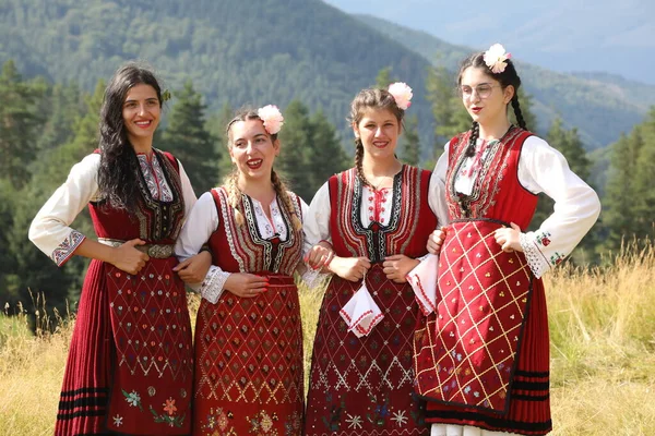 Koprivshtica, Bulgaria - August 6, 2022: People in traditional folk costume of The National Folklore Fair in Koprivshtica. The National Folklore Fair in Koprivshtica is entered in the UNESCO Register of the human intangible cultural heritage