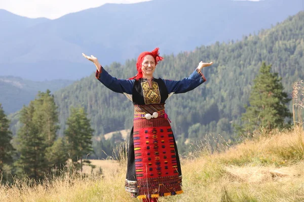 Koprivshtica, Bulgaria - August 6, 2022: People in traditional folk costume of The National Folklore Fair in Koprivshtica. The National Folklore Fair in Koprivshtica is entered in the UNESCO Register of the human intangible cultural heritage