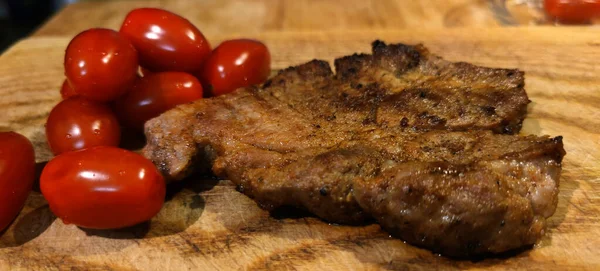 Grilled Pork Neck Steak Wooden Table Small Cherry Tomatoes Photo — Stock fotografie