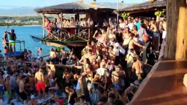 Pag, Zrce, Croatia, July 22, 2022: View of young people dancing to music in a club by the sea in a pool full of foam, summer party on the background of the sea, NOA beach club, summer fun, foam party