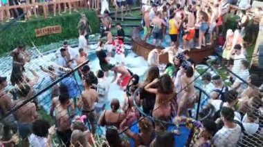 Pag, Zrce, Croatia, July 22, 2022: Young people dancing to music in a club by the sea in a pool full of foam, summer party on the background of the sea, NOA beach club, summer fun, foam party