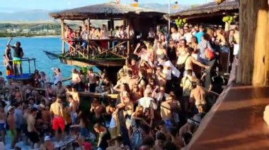 Pag, Zrce, Croatia, July 22, 2022: View of young people dancing to music in a club by the sea in a pool full of foam, summer party on the background of the sea, NOA beach club, summer fun, foam party