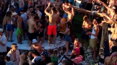 Pag, Zrce, Croatia, July 22, 2022: Close-up view of young people dancing to music in a pool full of foam, Namori dance club