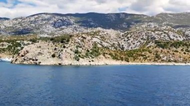 View of the Croatian coast from the moving ferry from the island of Pag, sea view, slow motion