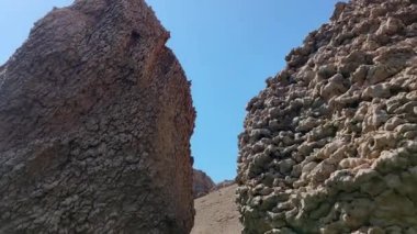 Close-up View of the sea from the Croatian beach Beritnica, view of the big stones that are in the sea, in the background the mountain range of the island of Pag