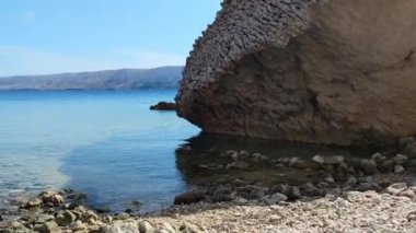 Detailed view of the sea from the Croatian beach Beritnica, view of the large stones that are in the sea
