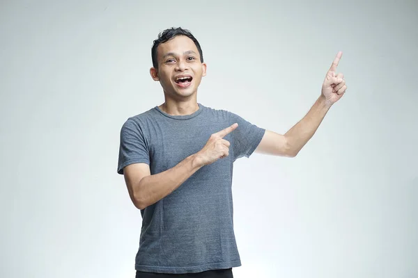 Handsome Asian Man Smiling Pointing Gesture Isolated Studio Background — Stockfoto
