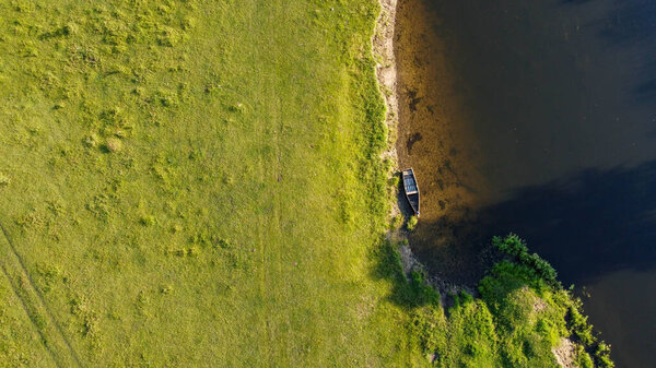 Boat near the river bank shooting with a drone. High quality photo