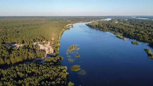 the Dnieper river flows among the forests and fields, ukraine filming from a drone. view from above. High quality photo