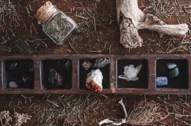 Flat lay shot of a collection of many different crystals on a messy wiccan witch's altar. Crystal magick