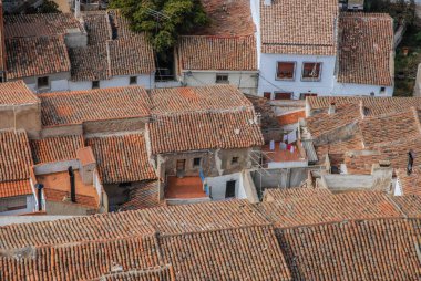 Red tiled rooftops of houses in the narrow streets of city, Almansa, Albacete Province, Spain