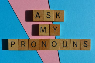 Ask My Pronouns, words in wooden alphabet letters isolated on pink and blue background clipart