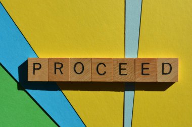 Devam et, kelime ahşap alfabe harfleriyle renkli arkaplanda izole edilmiş.