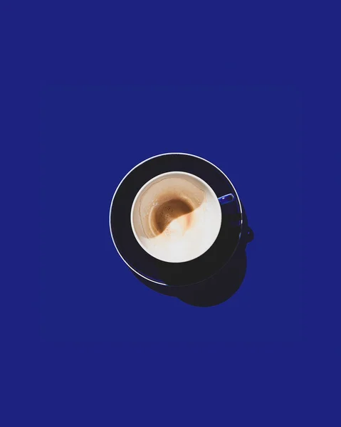 Синяя чашка со следами только что выпитого кофе на синем фоне. Копирование пространства. — стоковое фото