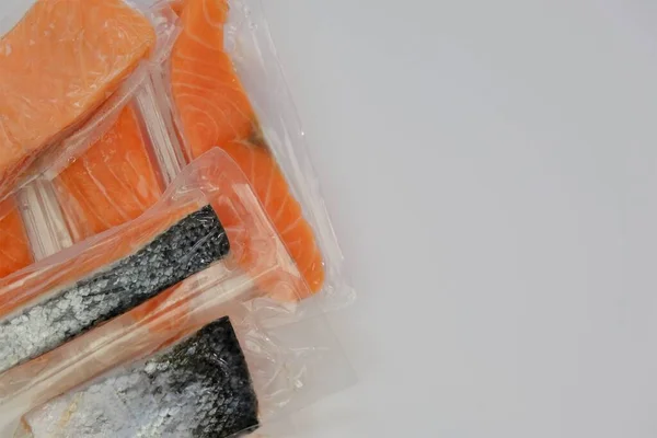 Salmon fish.Fish and seafood. fish pieces. Pieces of frozen salmon in vacuum bags