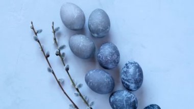 Marble Easter Eggs.Easter food. Easter eggs in gray tones and sprigs of pussy willow on a gray background.Easter holiday symbol