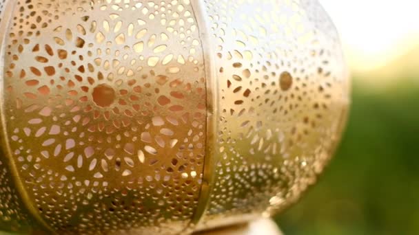 Ramadan time.Muslim golden lantern Mubarak in the sunbeams on a green blurred background . Muslim holiday Ramadan. — Stock Video