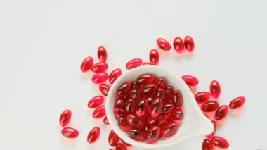 Beyaz arka planda kril yağı kırmızı jelatin kapsülleri. Omega yağ asitleri. Doğal takviyeler ve vitamin.