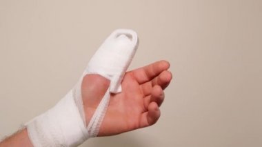 White bandages and a splint on the arm.Broken arm.Bandage and splint on the finger.Bandaged hand.Fractures and sprains.Medicine concept. Surgical dressing.