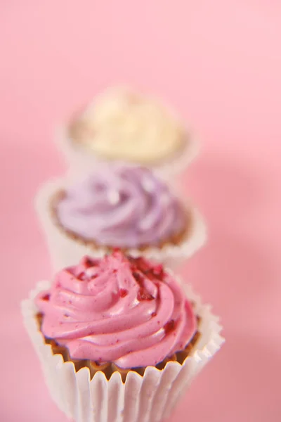 Crema cupcakes.cakes sobre un fondo rosado. Surtido de mesa dulce. Dulces y postres —  Fotos de Stock