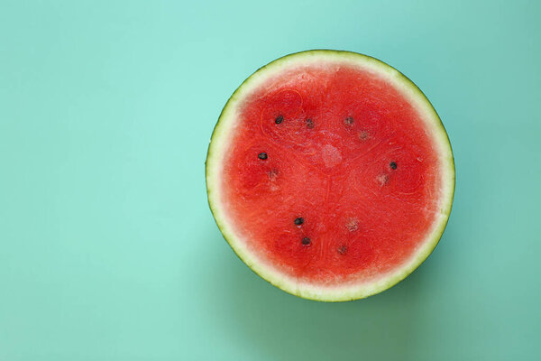 Watermelon in a cut on a green background. Watermelon pulp close-up. ripe red watermelon half