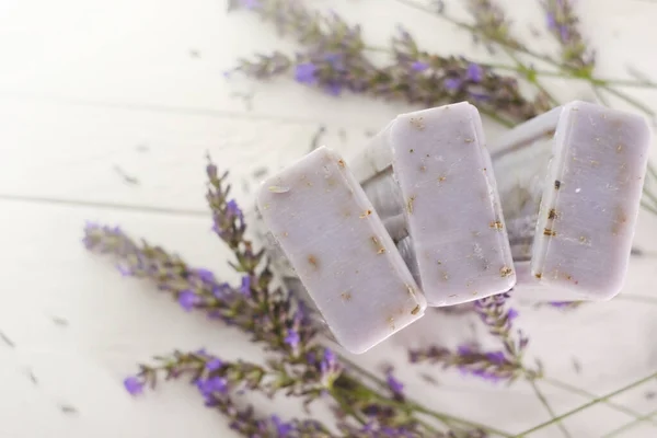 Lavender soap bars and lavender branches on a shabby chic background.lavender scent.Beauty and aromatherapy. — Stock Photo, Image