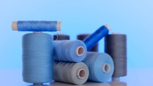 Needlework and sewing. Sewing threads set.Blue and gray thread spools on a light blue background.Hobby and handicraft — Stock Video