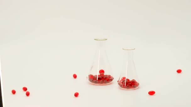 Krill oil red gelatin capsules in flasks.Flying capsules red krill oil on a white background.Source of omega 3 fatty acid. Suplemen alami dan vitamin — Stok Video