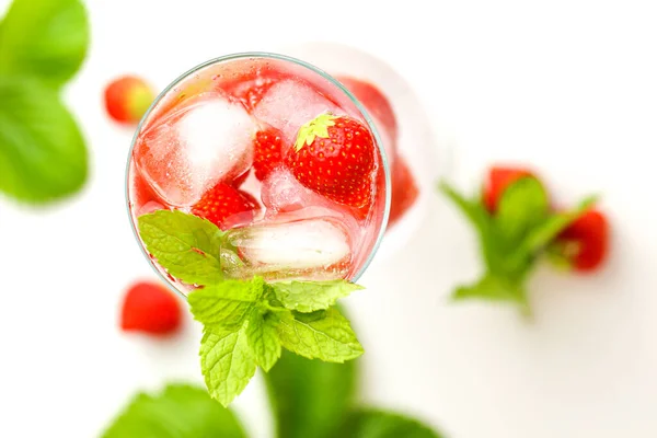 Cocktail framboise.Drink.raspberry d'été rose drink.Ice cubes aux framboises dans un verre avec de l'eau, des baies et des feuilles de framboise sur une table en bois blanc. cocktail rafraîchissant. — Photo