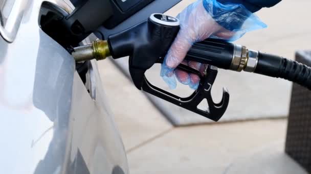 Diesel.man fills up a car tank with diesel fuel. Refueling the car.Refueling pistol in the hands of a man in a blue glove. Fuel price in Europe. — Vídeo de Stock
