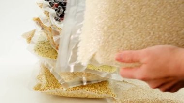 Storage of products in vacuum bags.Stocks of provisions.food supply.Vacuuming products for long term storage. Stocks of cereals, pasta and dry berries in vacuum bags 
