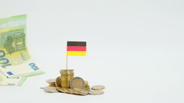 Economic recession in Germany. Depreciation of the euro currency. Euro banknotes and flag of Germany in euro coins on a white background.Economy of Germany. Financing in Germany. — Vídeos de Stock