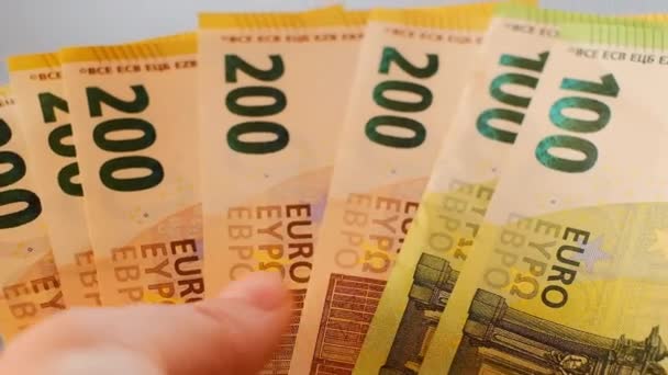 Τραπεζογραμμάτια ευρώ σε χέρι close-up.Euro νόμισμα. Χρήματα στα χέρια σε θολή γκρι φόντο.Επαναφόρτωση των χρημάτων. — Αρχείο Βίντεο