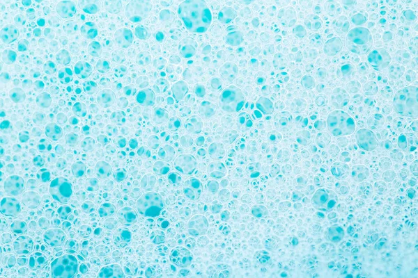 white foam bubbles.Cleanliness and hygiene background. Foam Water Soap Suds.Texture Foam Close-up. blue soap bubbles background.Laundry and cleaning background.foam bubbles.