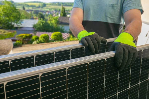 Solar panel in the hands of a worker.solar power technology.Smart consumption and energy saving. Fitting and installation of solar panels.Green energy.alternative energy from nature.Purchase of solar