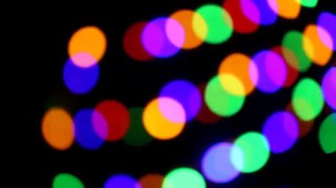 colorful bokeh background. Multicolored garlands on a black background. colorful spots background. Christmas background. Glowing bokeh. 